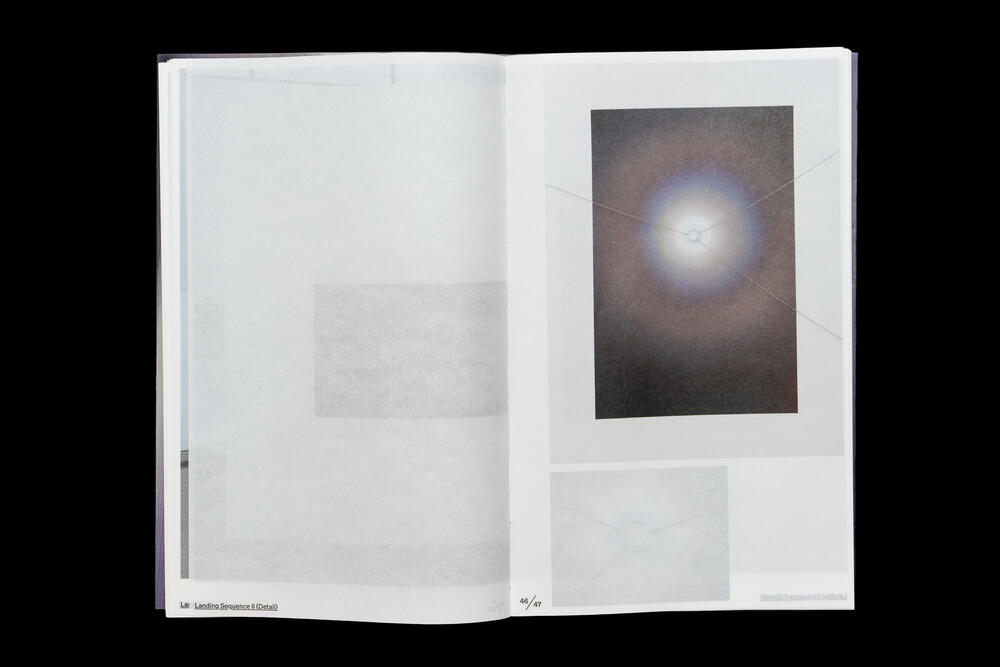 An open exhibition catalog displaying a photograph of a luminous orb or celestial body against a dark background on the right page, with blank space on the left page.