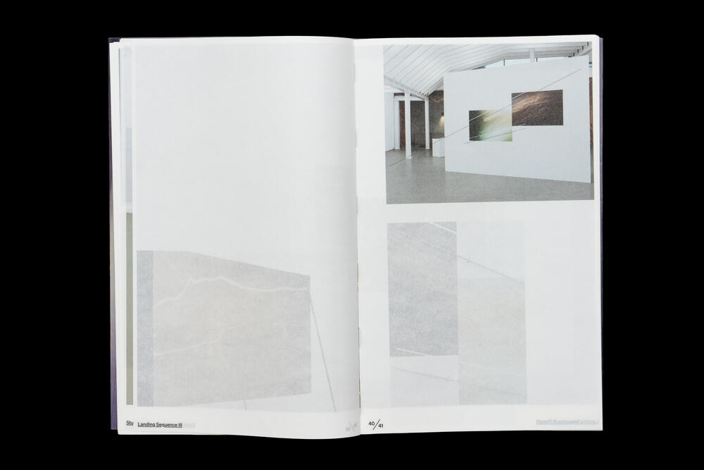 An open exhibition catalog spread displaying gallery installation photographs on the right page, with minimal text and layout against a clean white background on the left page.